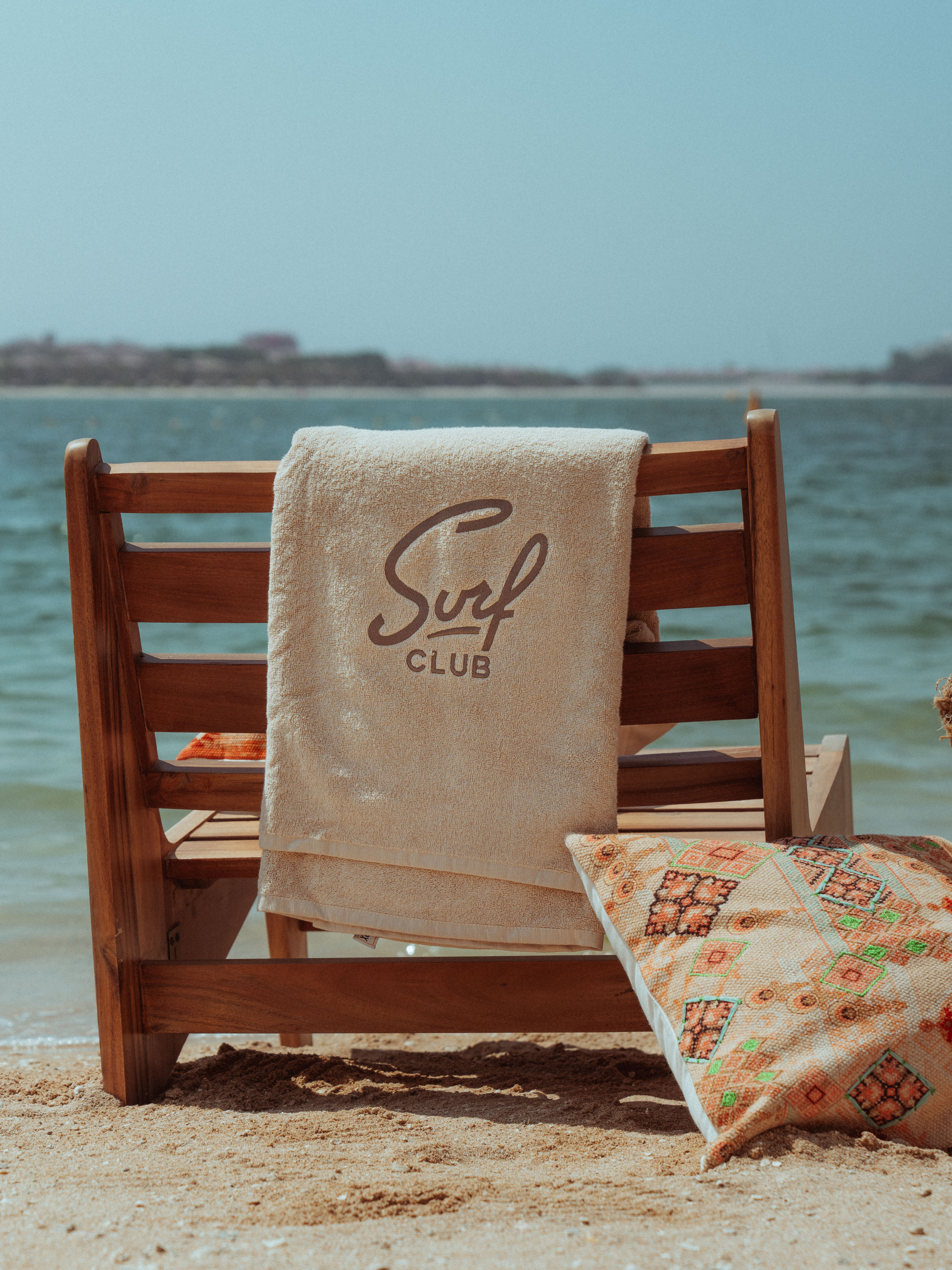 Surf Club beach chair with branded towel on the North Coast shore