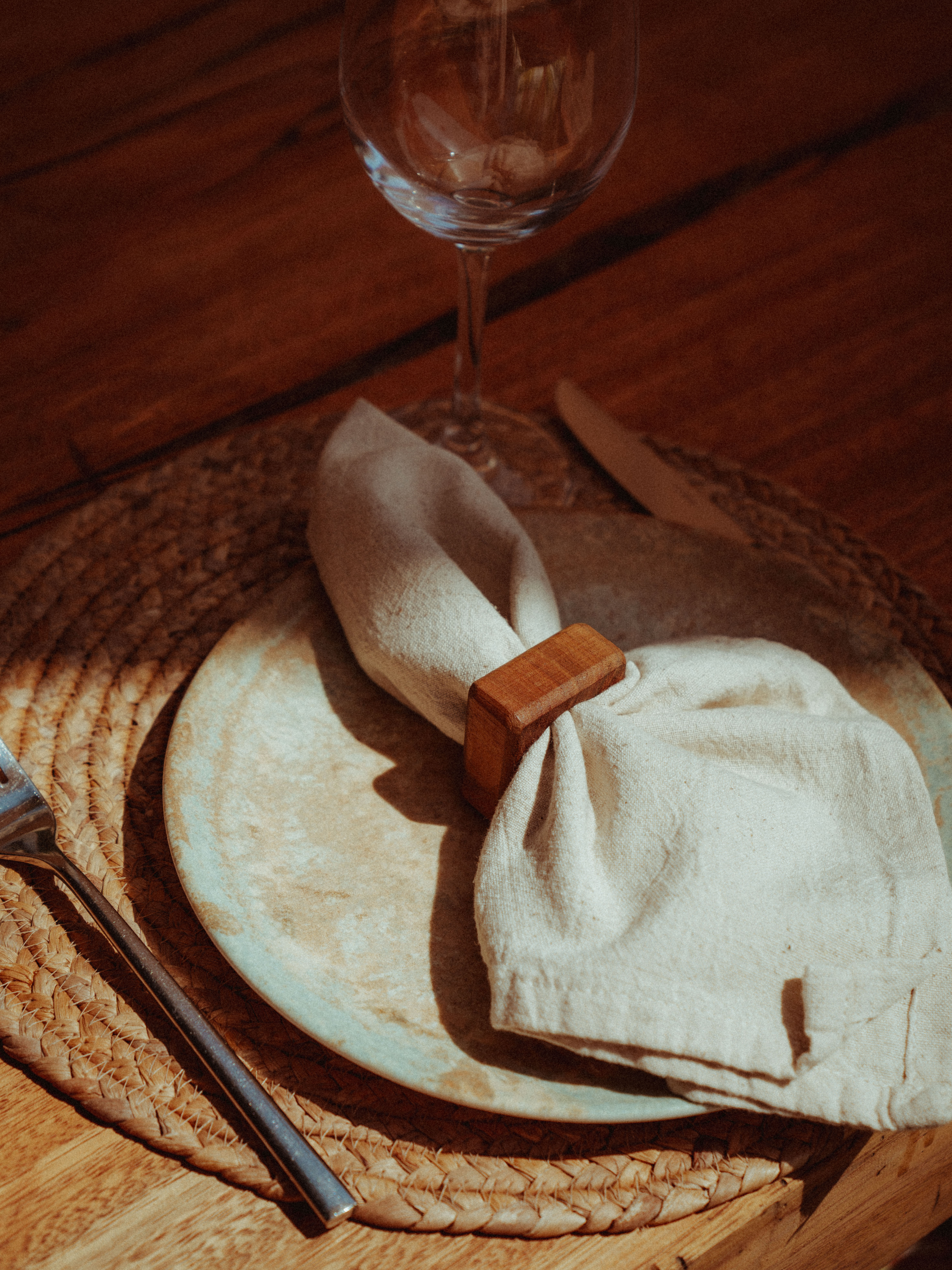 Surf Club table setting with linen napkin and wooden ring